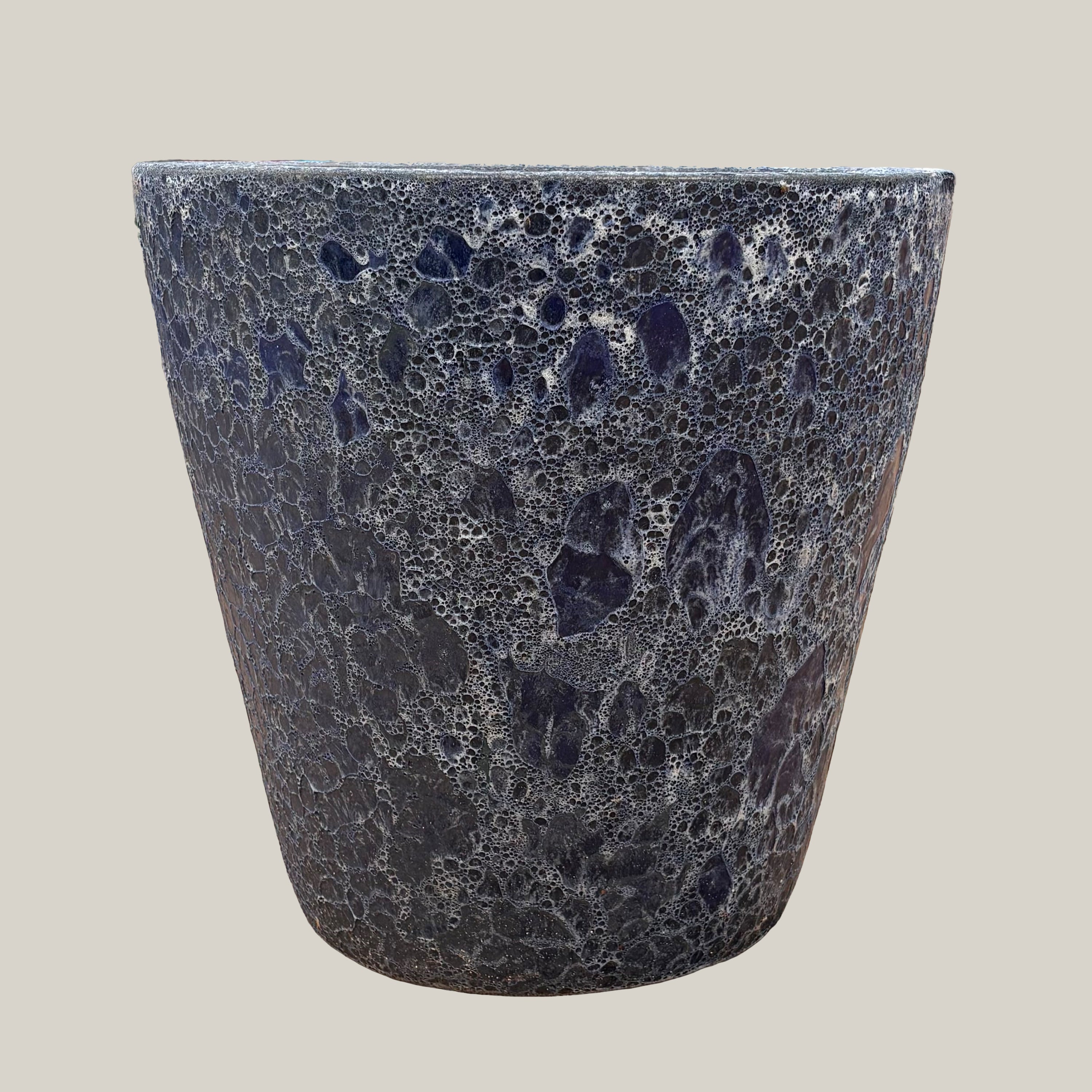 Front view of blue coral tapered planter with bold tapered silhouette and decorative coral-textured surface in deep blue tones