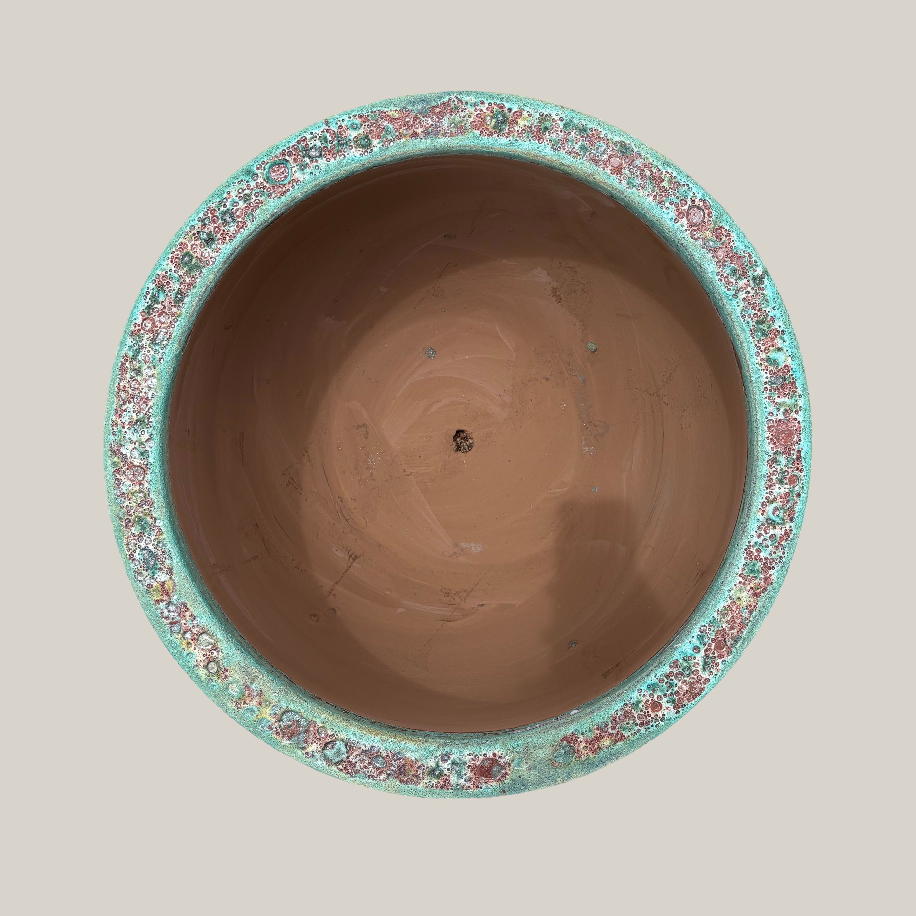 Top view of turquoise coral round low bowl planter showing wide opening and textured glazed interior