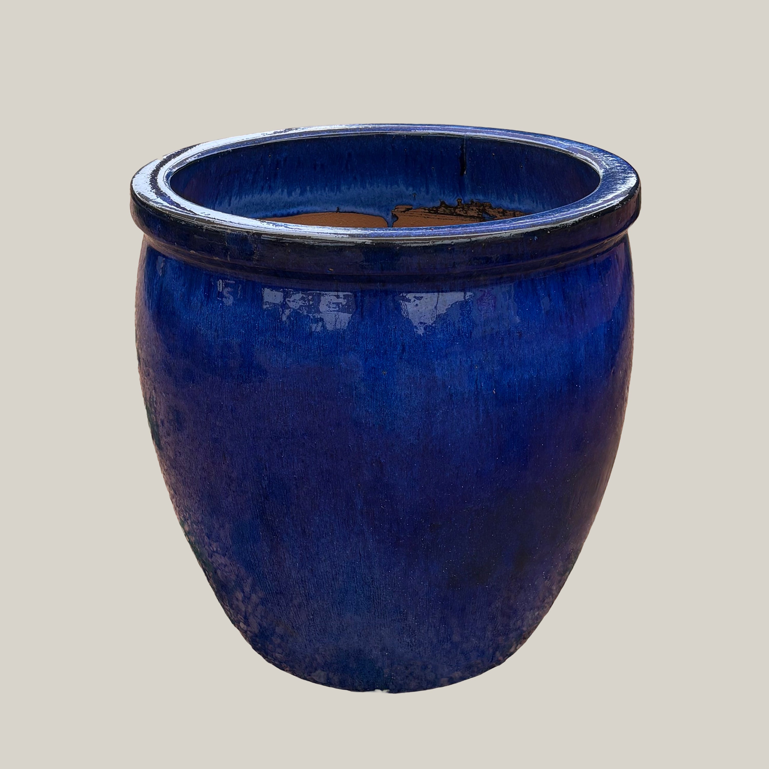 Blue belly planter with full, rounded body and glossy blue glaze, slightly angled view highlighting its curved silhouette