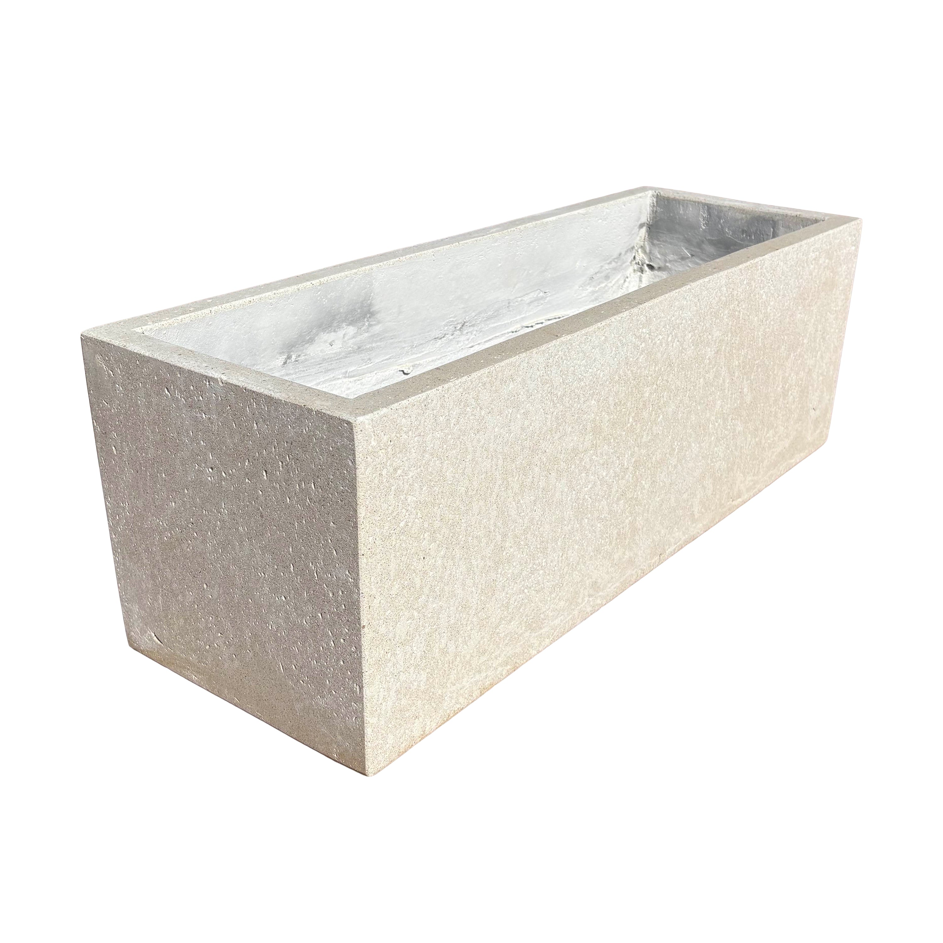 Low white rectangular fiberstone planter viewed at an angle, showcasing its sleek lines, shallow depth, and modern stone-look texture.