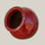 Bright red ceramic tilted vase for plants