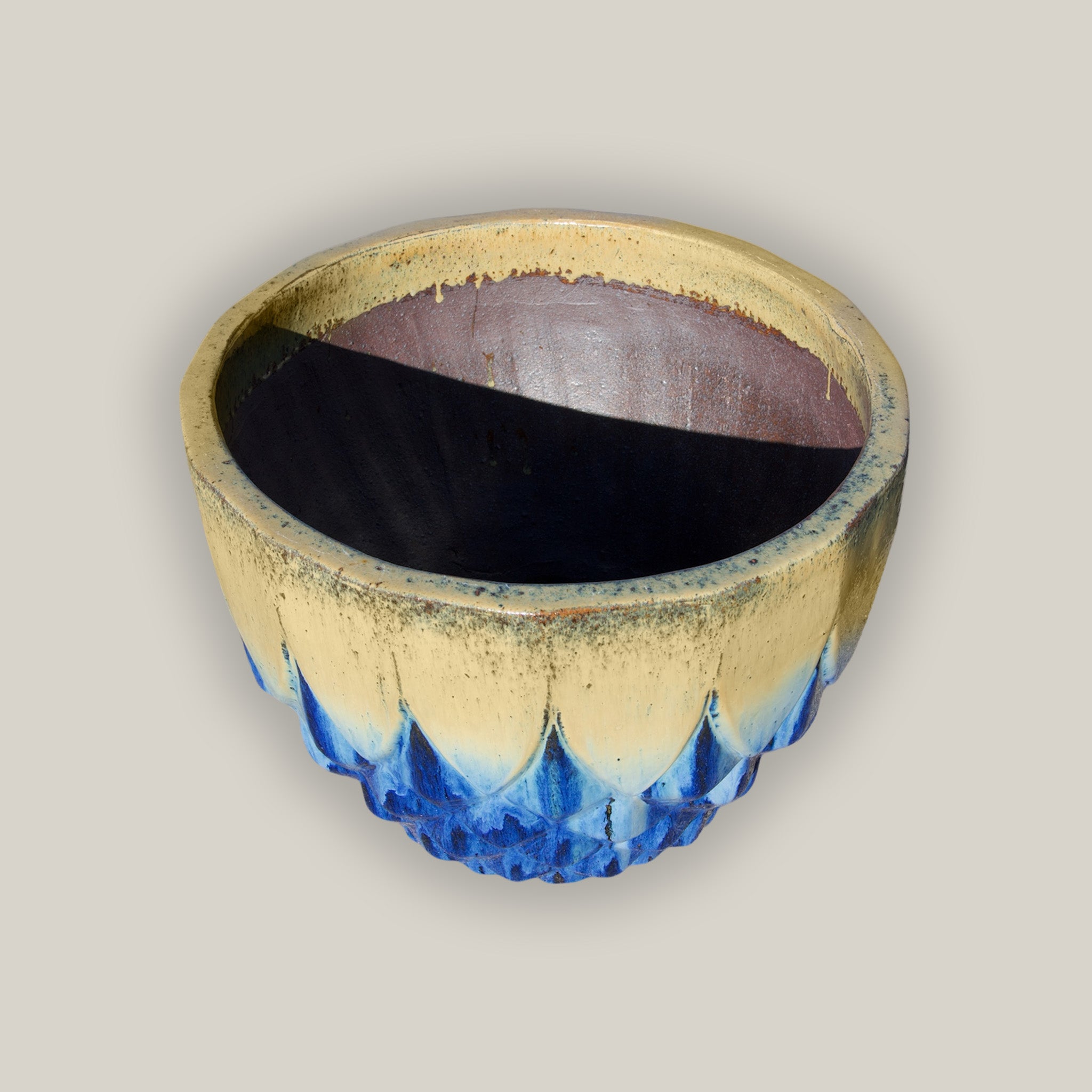 Angled Blue ceramic pineapple bowl with rustic cream top