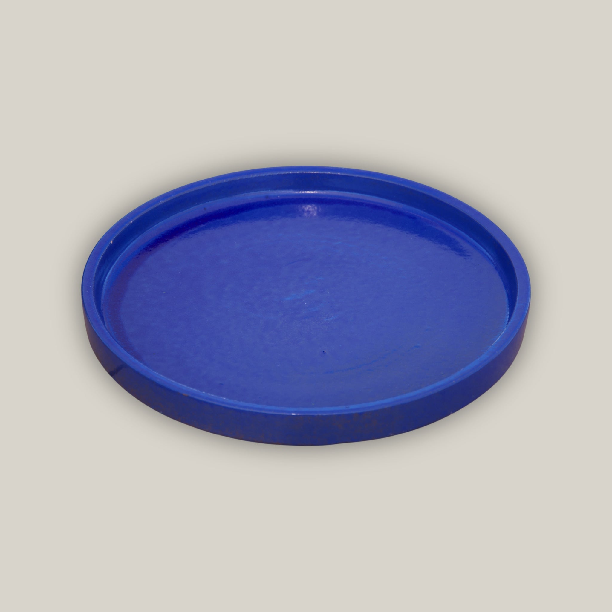 Round falling blue ceramic plant saucer