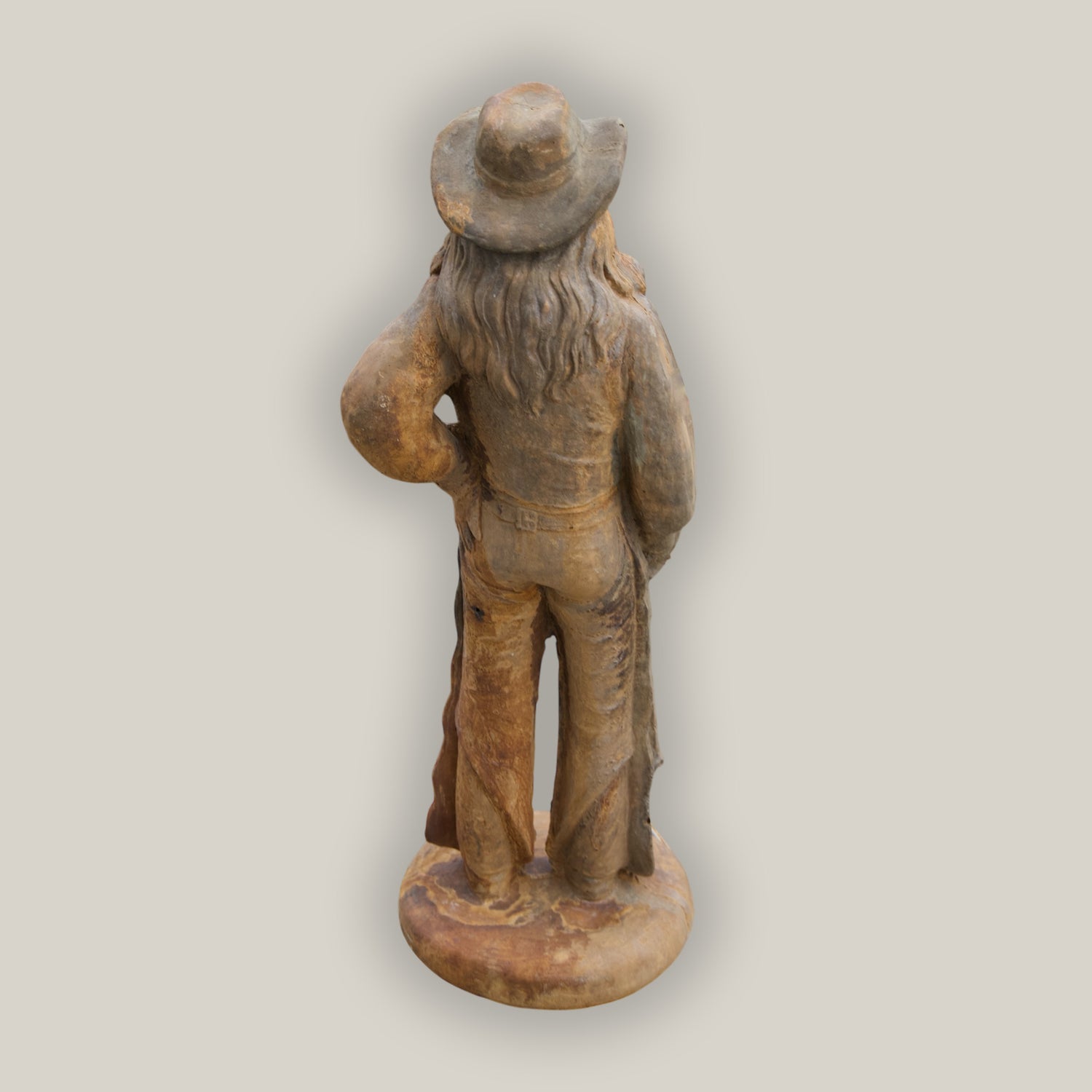 Back view of rust Cowgirl Statue