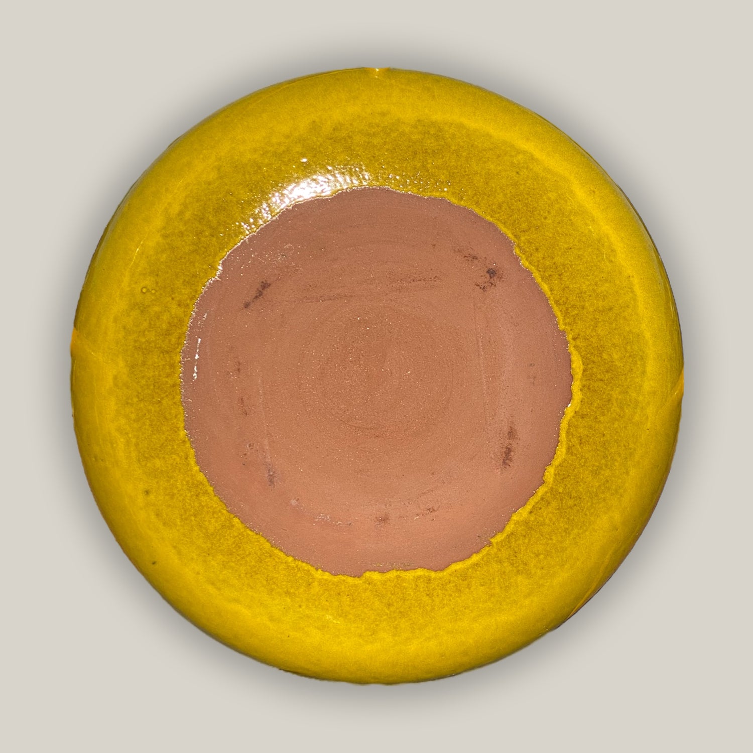 back of yellow ceramic bird bath bowl