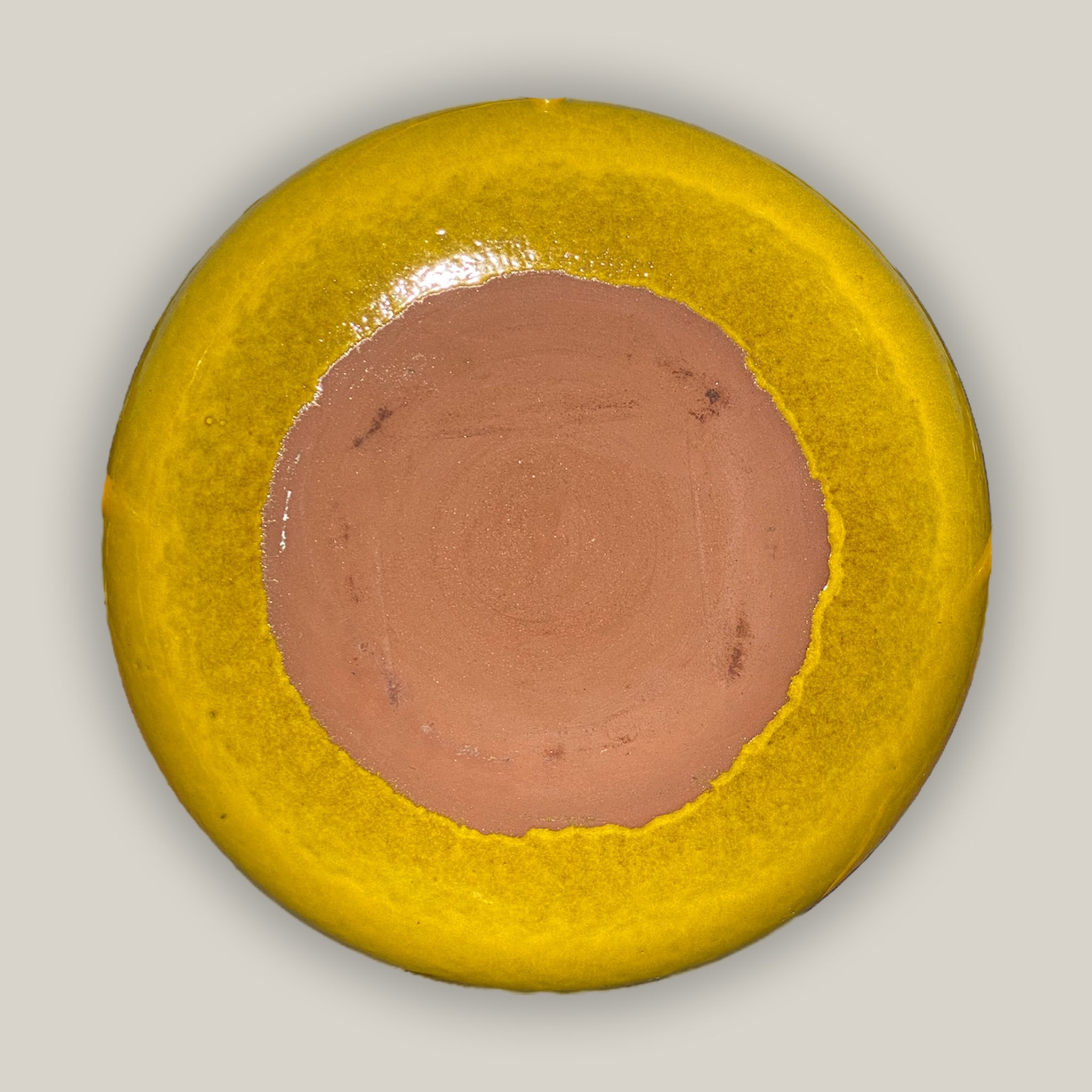 back of yellow ceramic bird bath bowl