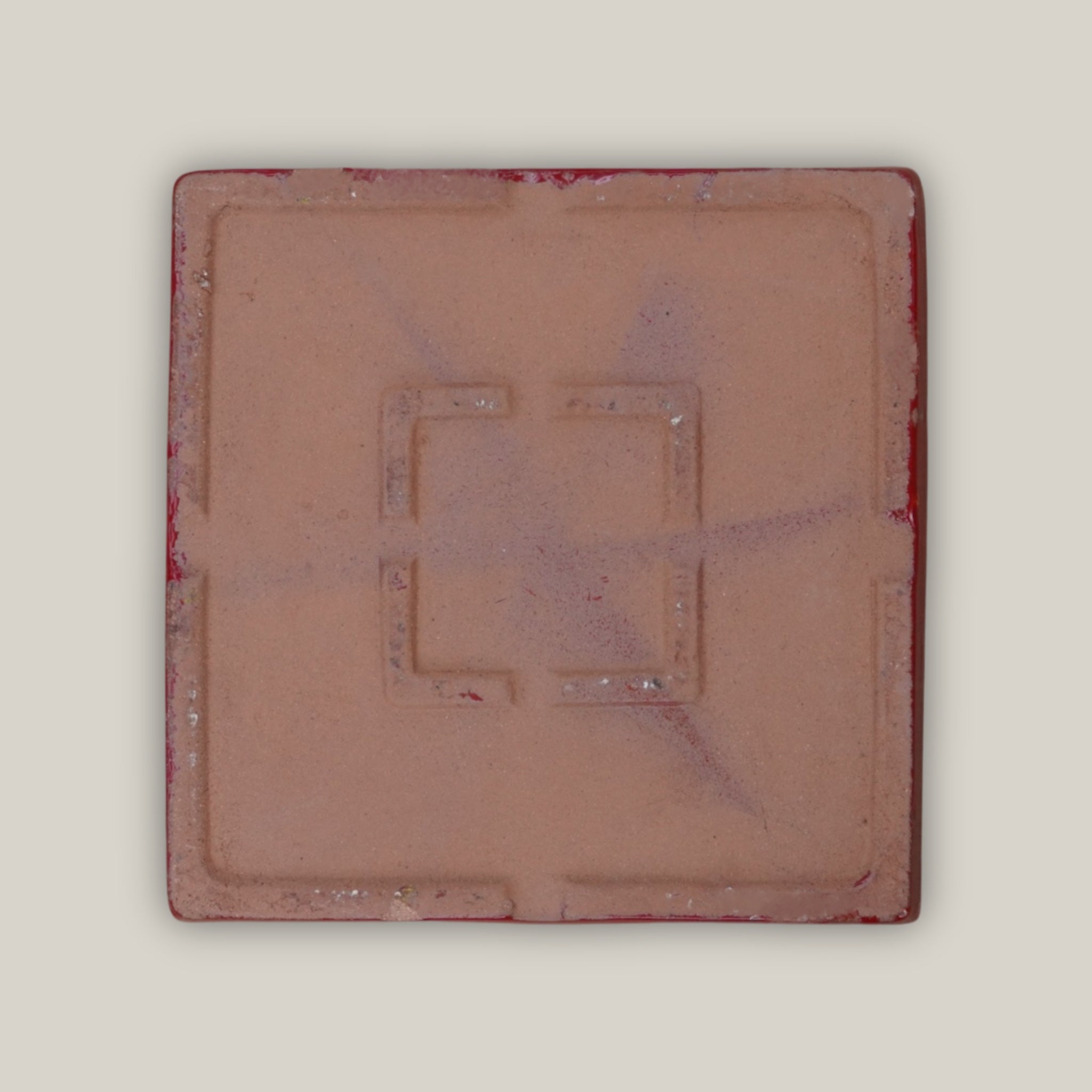 Bottom of Bright red square plant saucer