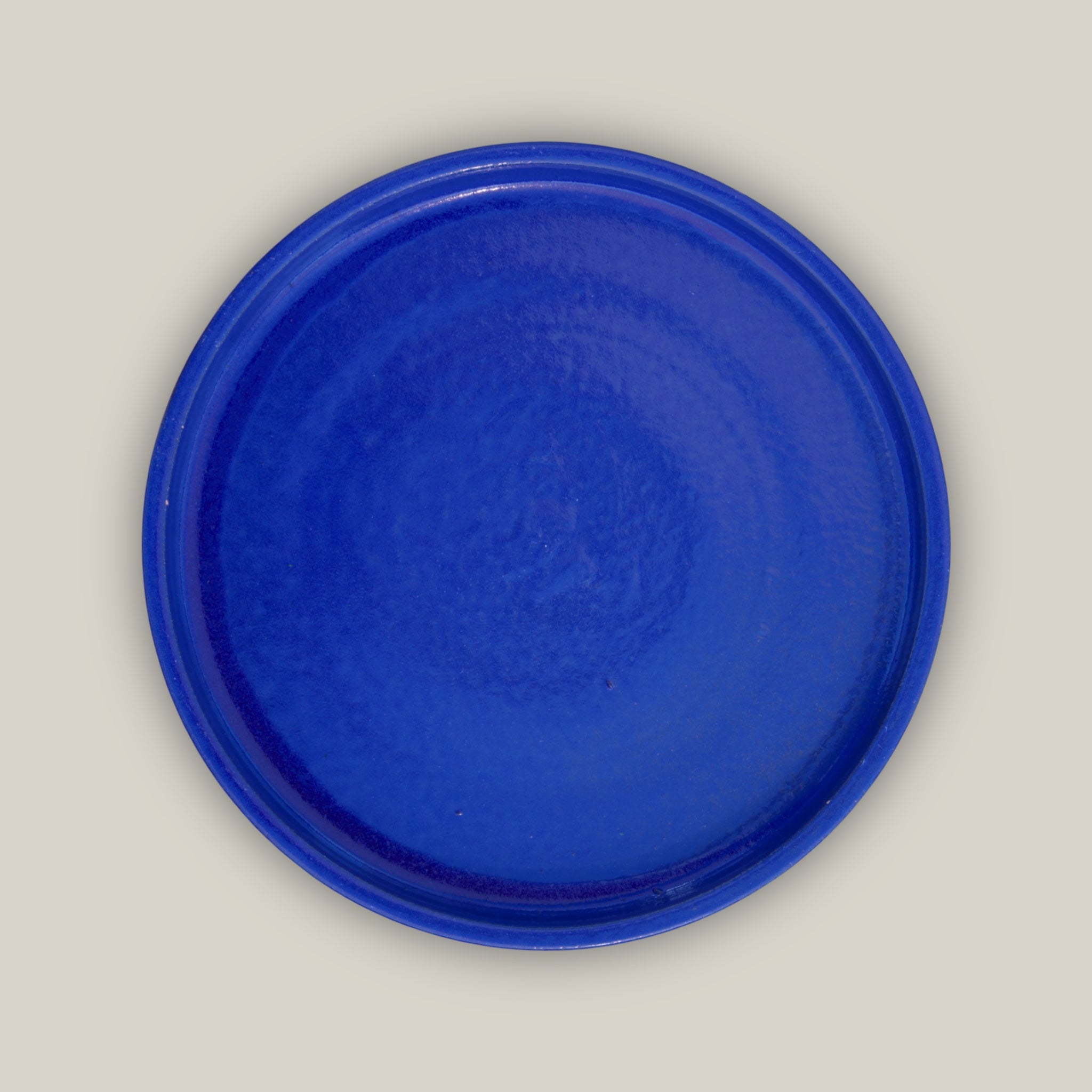 Round falling blue ceramic plant saucer