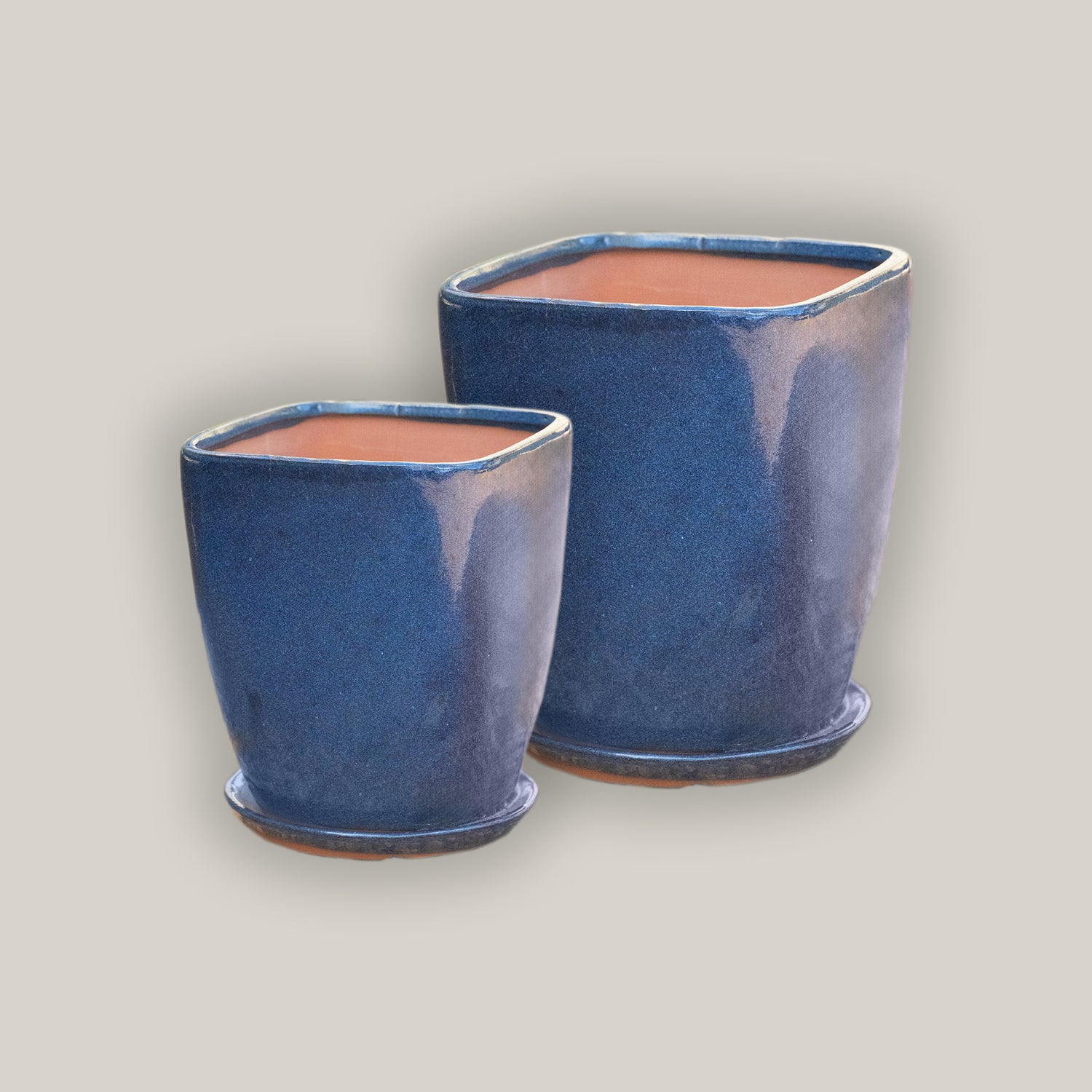 Ceramic dark blue tapered planter with saucer