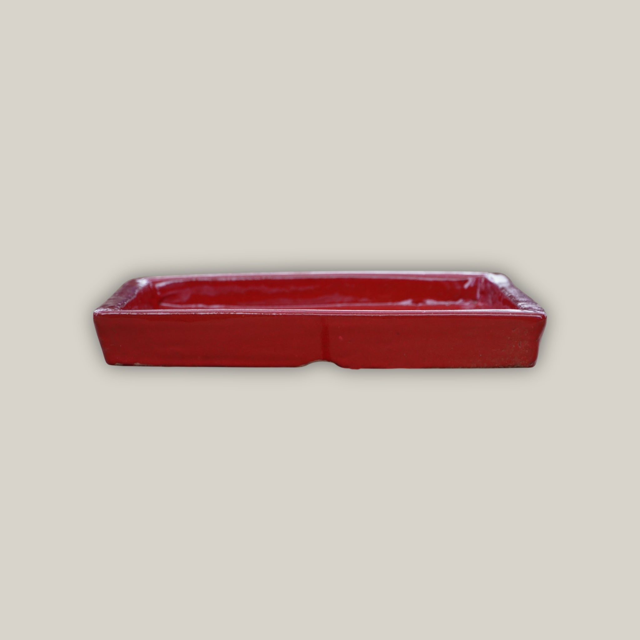 Bright red square plant saucer made from ecofriendly clay