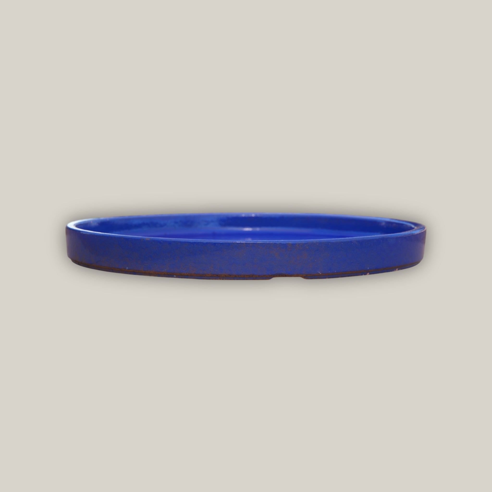 Round falling blue ceramic plant saucer