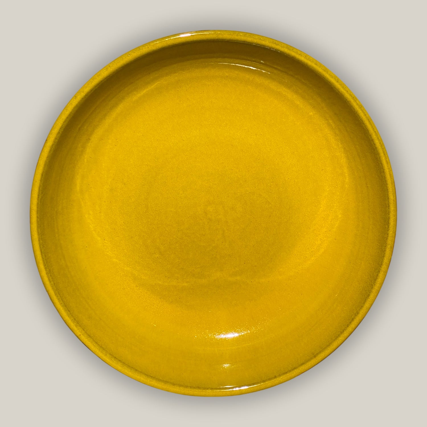 top view of yellow ceramic bird bath bowl