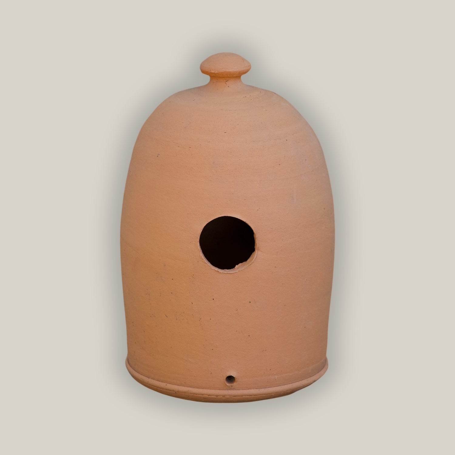 Terracotta bird house with natural rustic finish