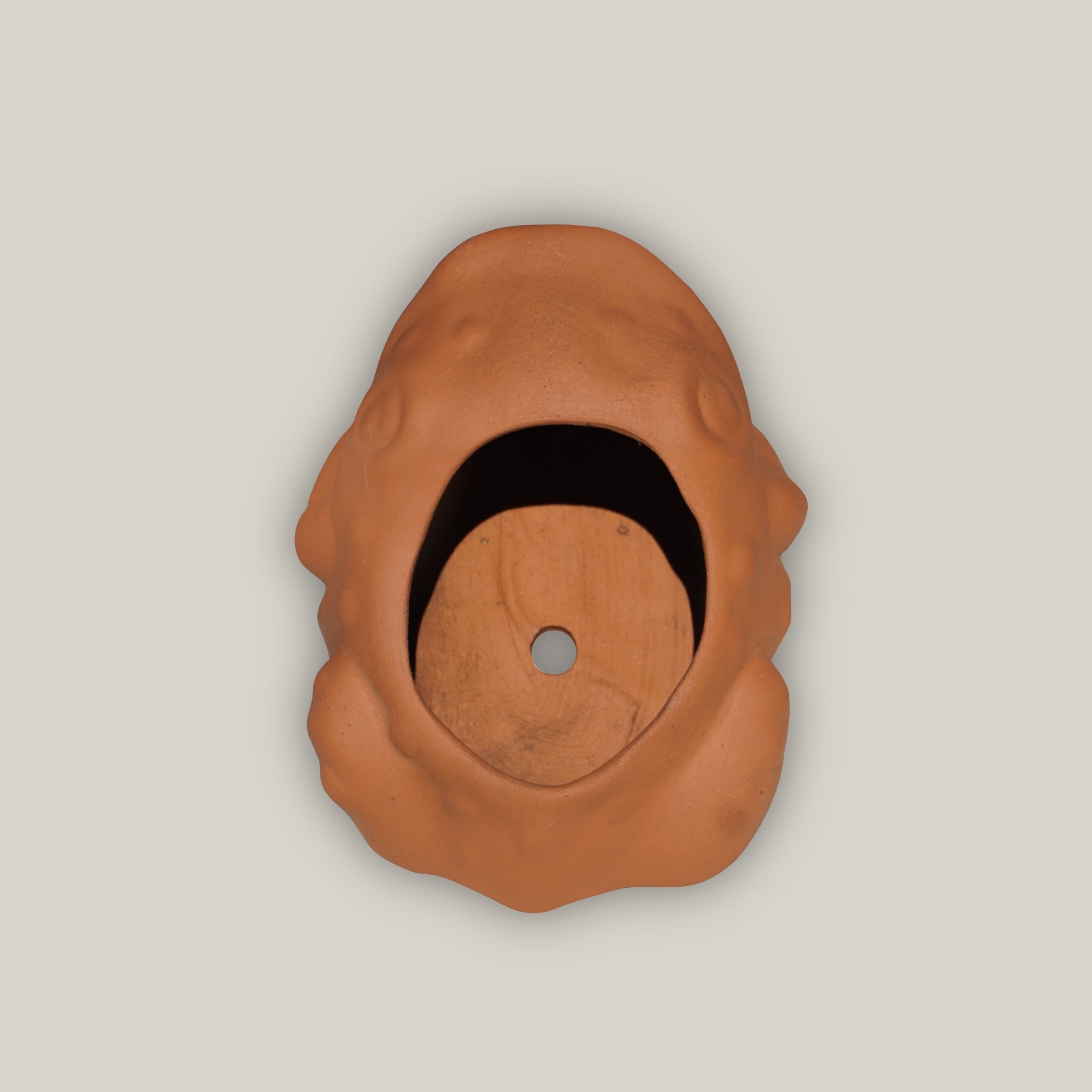 Top view of Terra cotta frog figurine with rustic clay finish