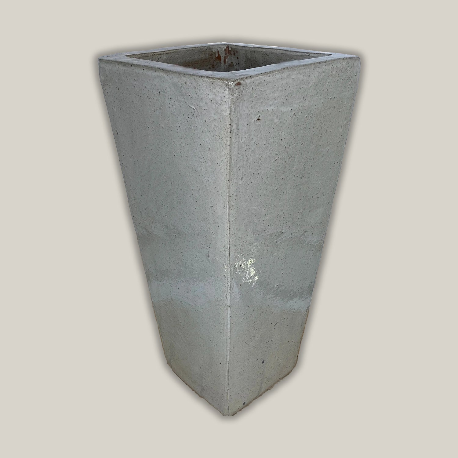 Tall white ceramic planter with glossy square wedge design