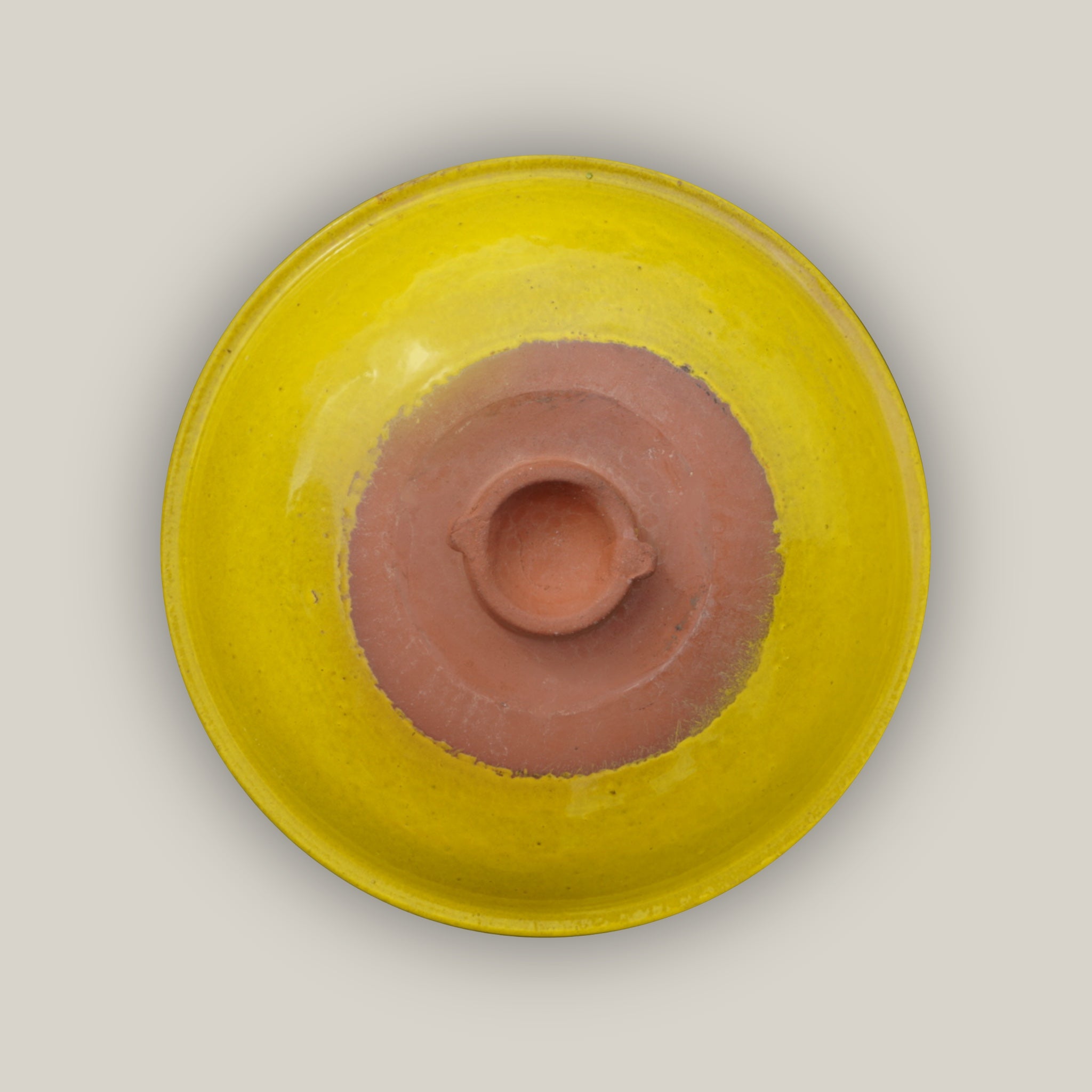 Bottom view of Yellow ceramic bird bath with hand-glazed finish