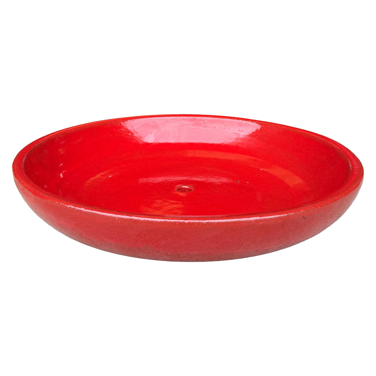 Angled view of a wide, shallow bright red ceramic succulent bowl with a vivid glossy interior, a rounded rim and a central drainage hole