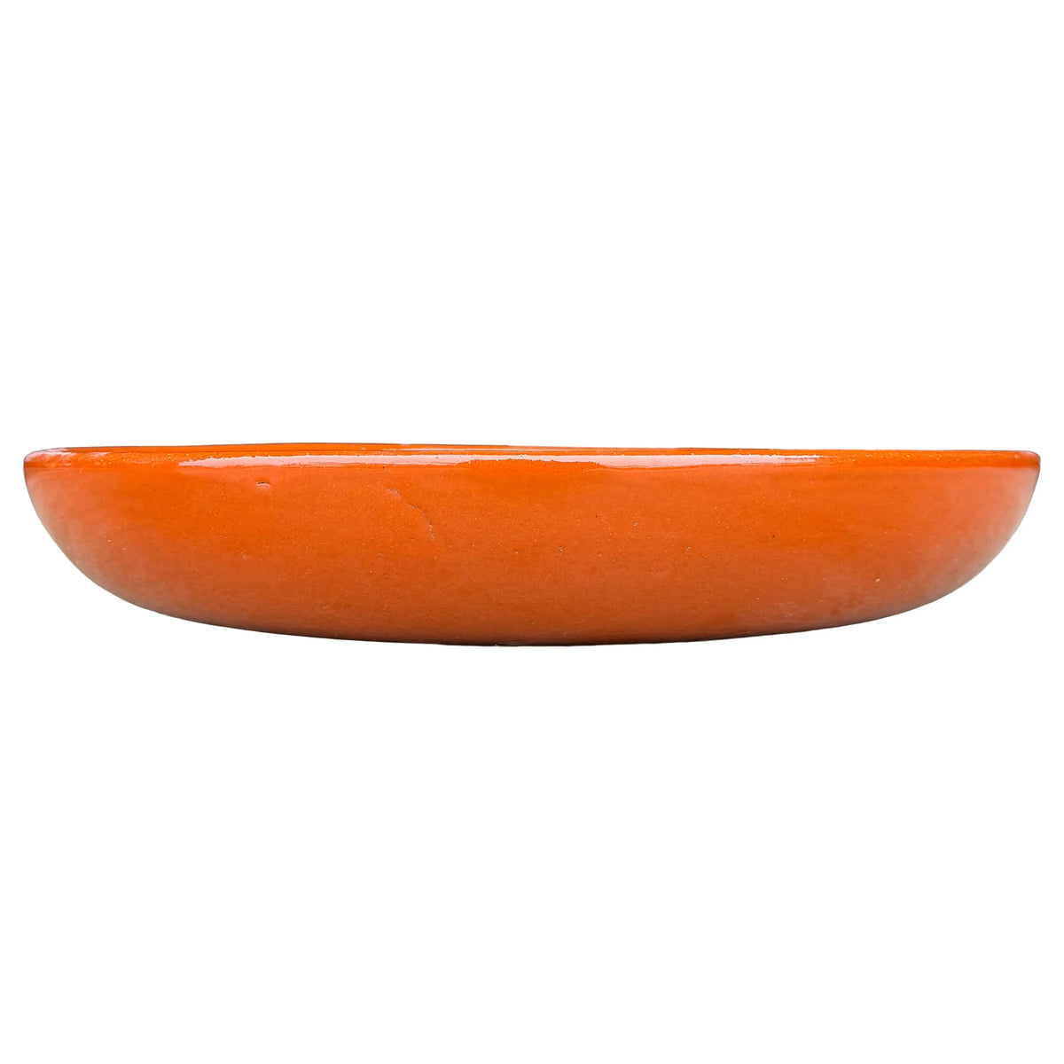 Eye-level front view of a shallow orange bird bath bowl with a low, rounded profile and a smooth, high-gloss glaze.