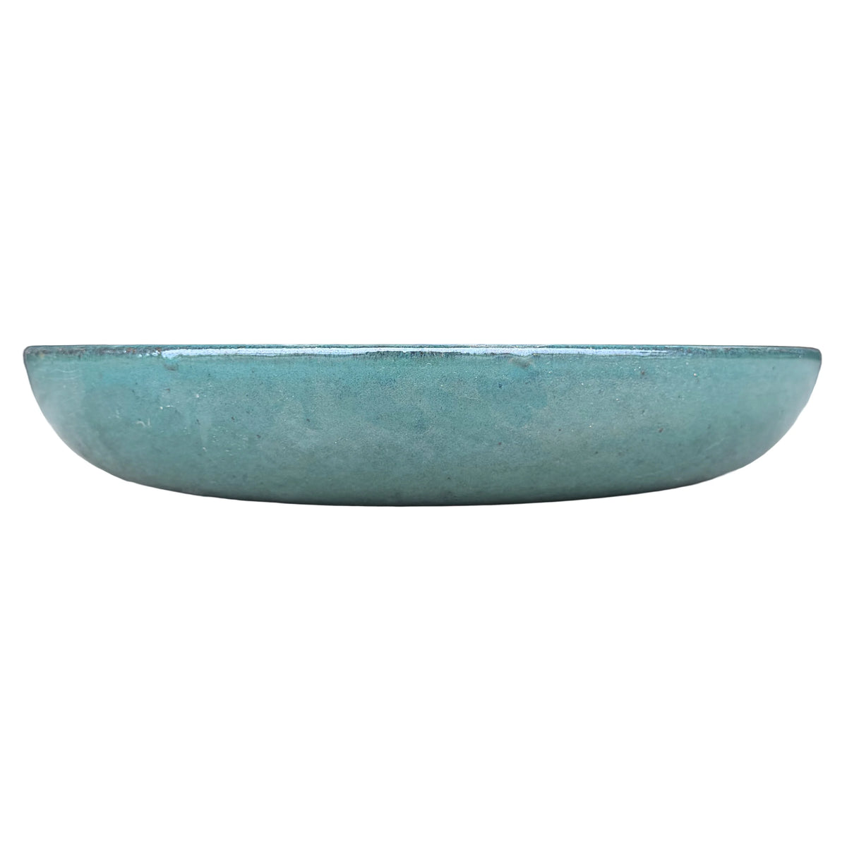 Eye-level front view of a jade ceramic succulent bowl, with a low, shallow profile and a glossy blue-green glaze with fine dark specks.