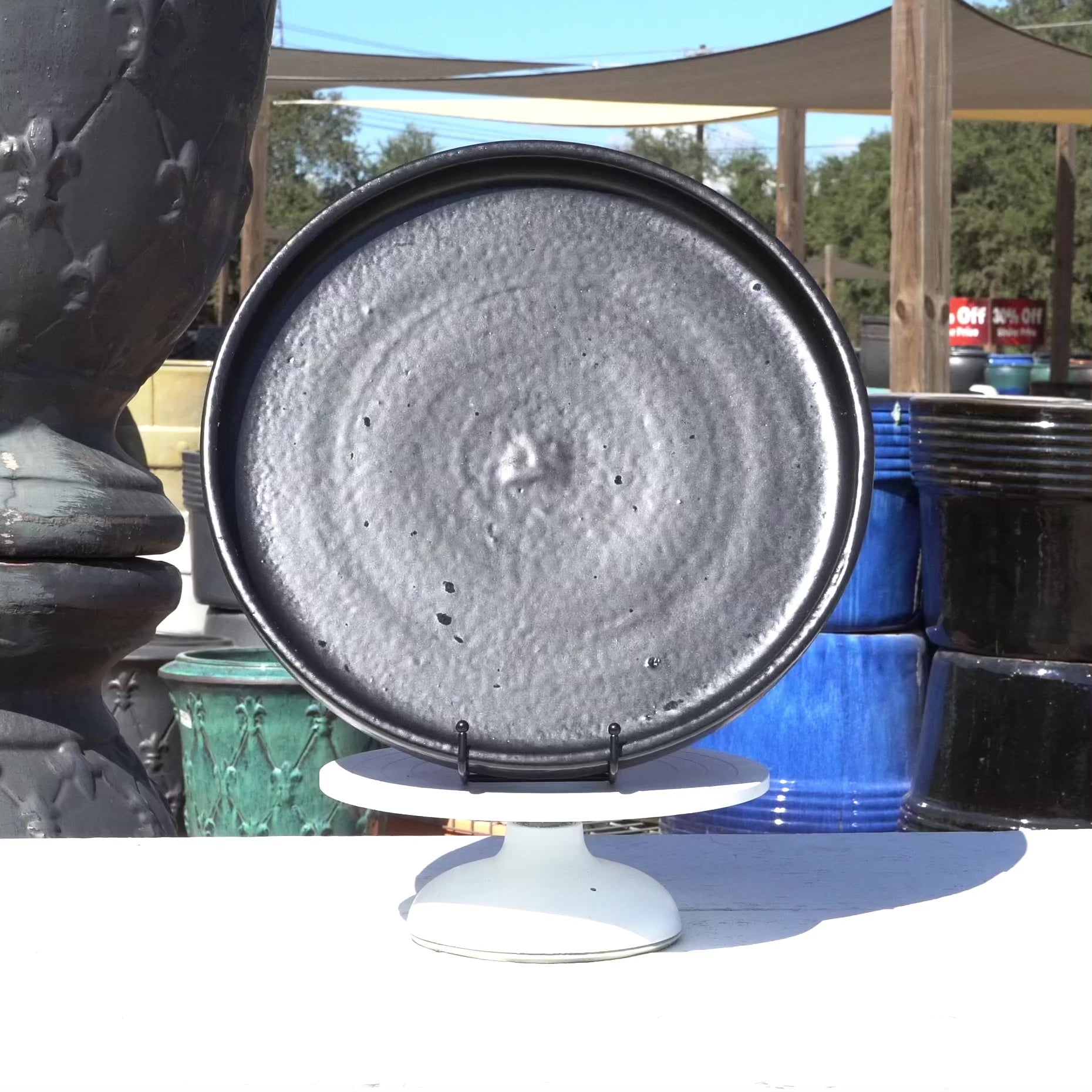 Round black ceramic plant saucer highlights