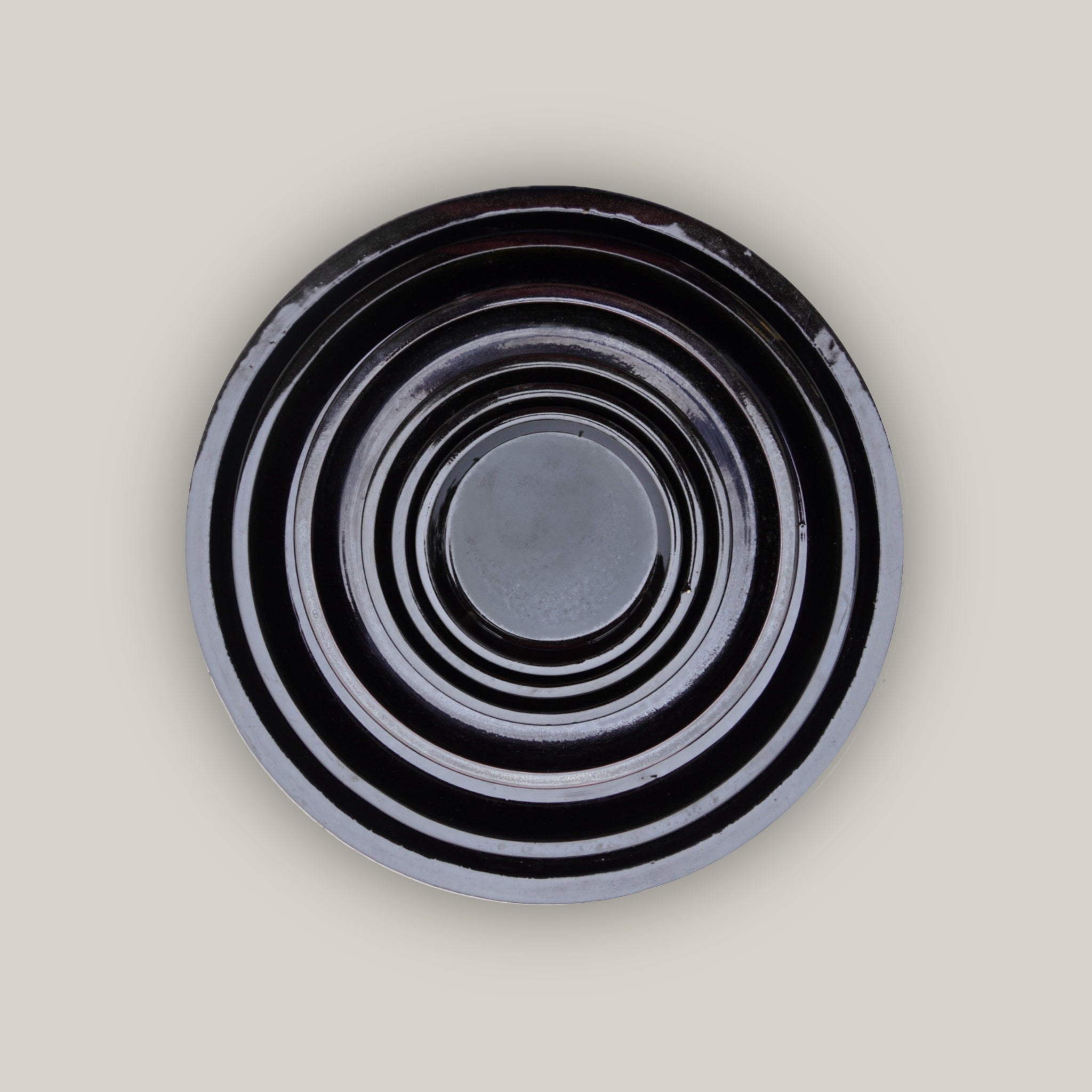 Round shiny black plant saucer made from ecofriendly clay