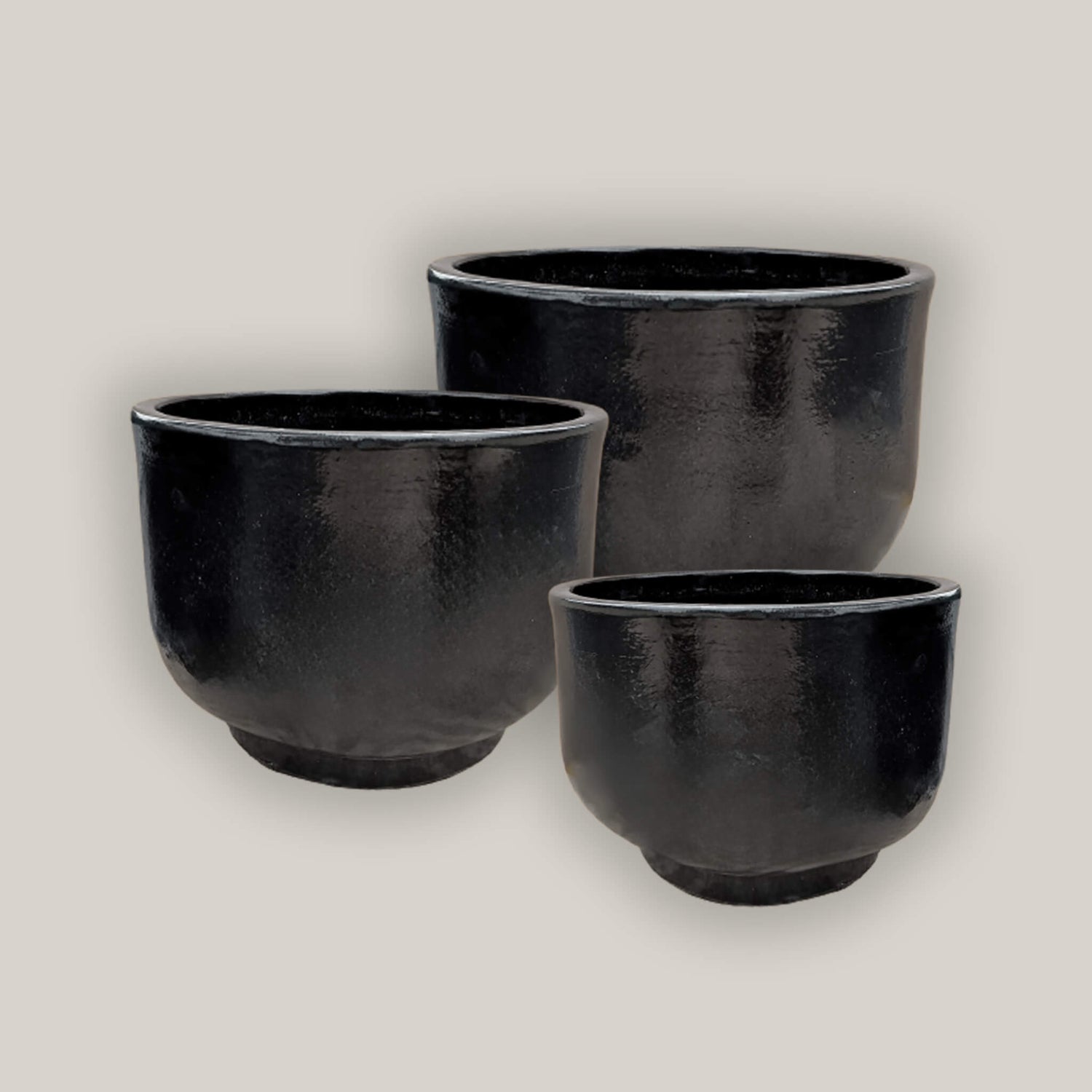 Collection of minimalist black planters for home or garden