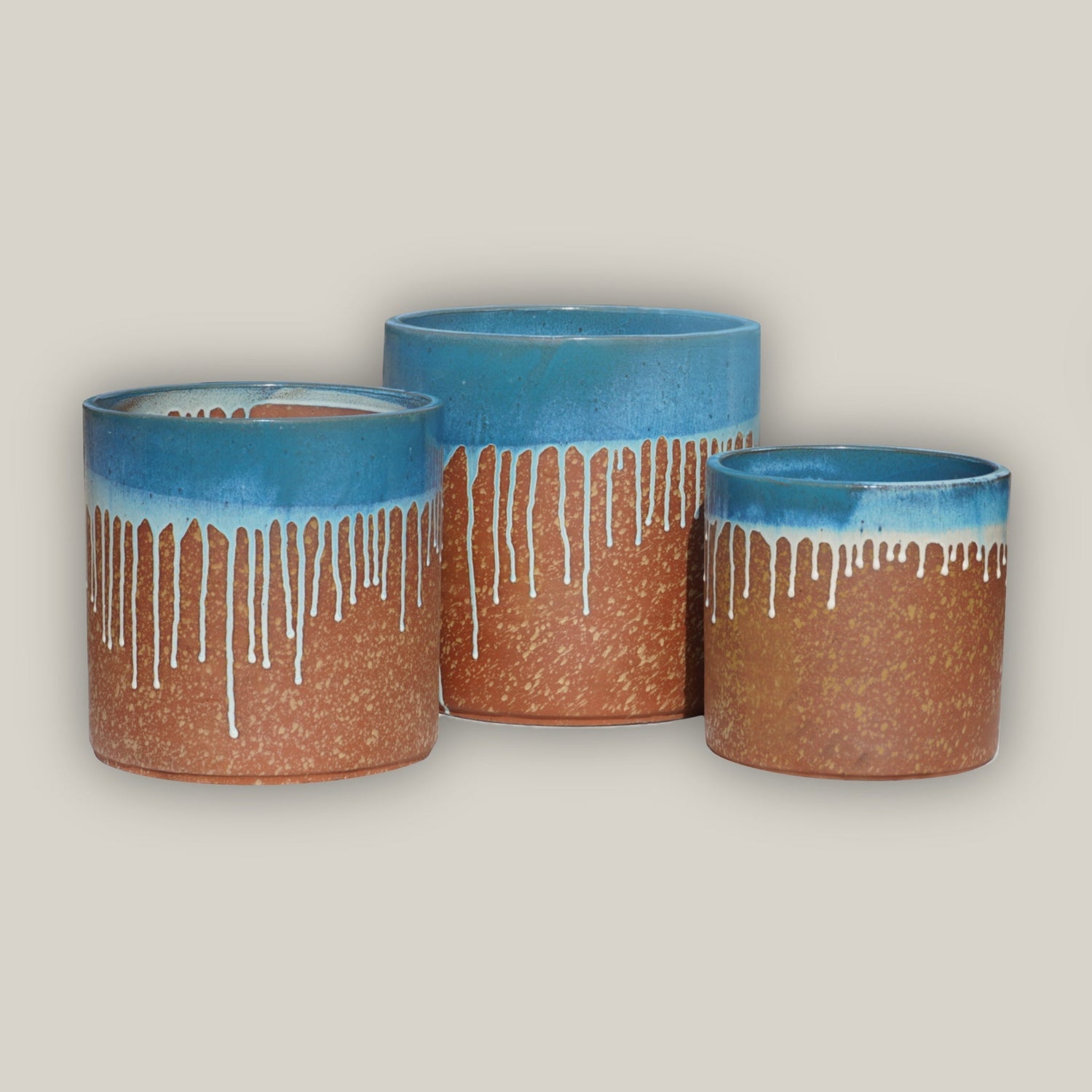 Brown glazed ceramic planters with blue rim and dripping effect