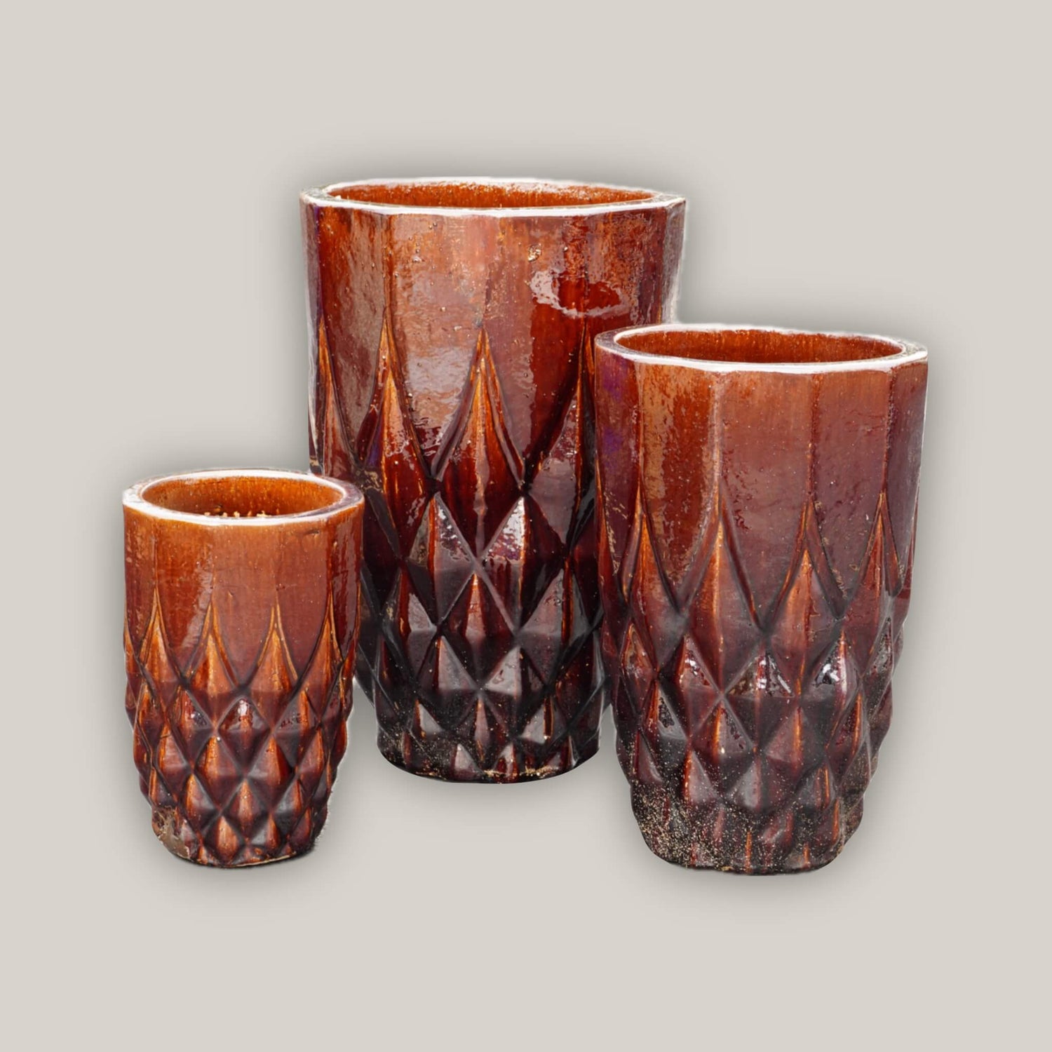 Brown ceramic planters with subtle pattern details