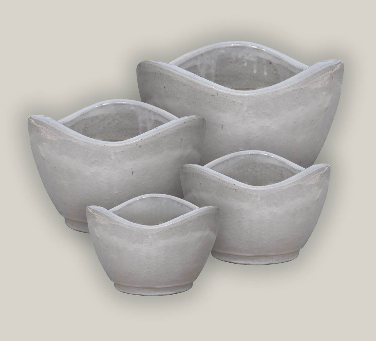 Collection of white ceramic planters with wavy rim