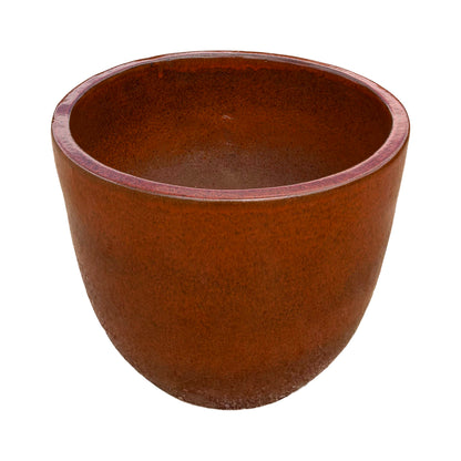 Tropical orange tapered round ceramic planter with a vibrant glazed finish shown from an angled perspective.