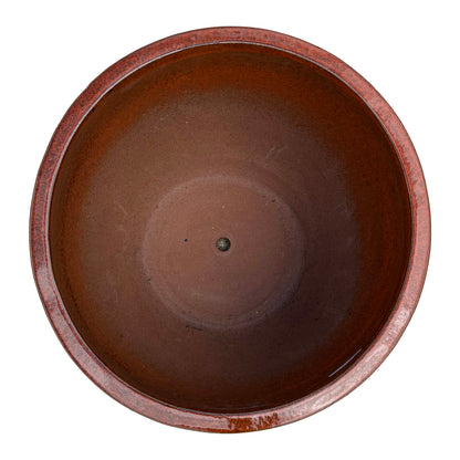 Top view of the tropical orange tapered round ceramic planter showing the wide opening and smooth glazed interior.