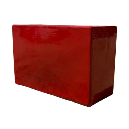 Bright red glazed rectangular ceramic planter shown from the side, highlighting its clean lines and rectangular profile.