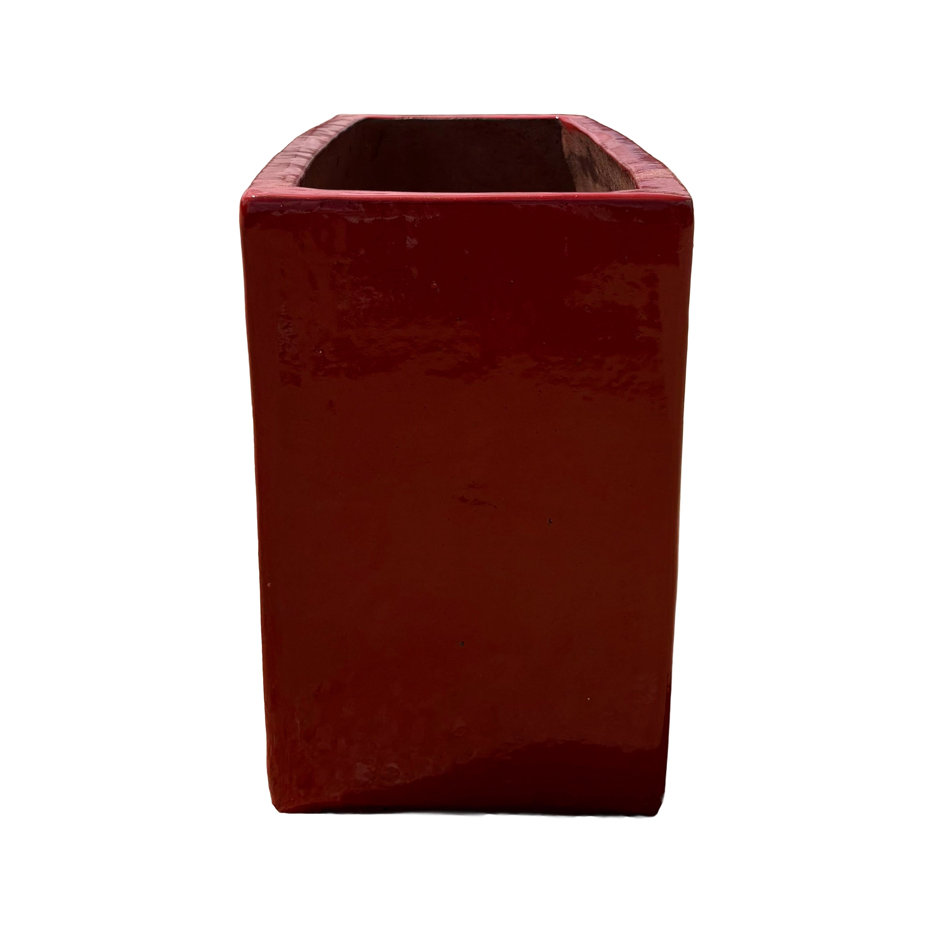 Short side view of the bright red glazed rectangular ceramic planter highlighting its compact end profile and glossy finish.
