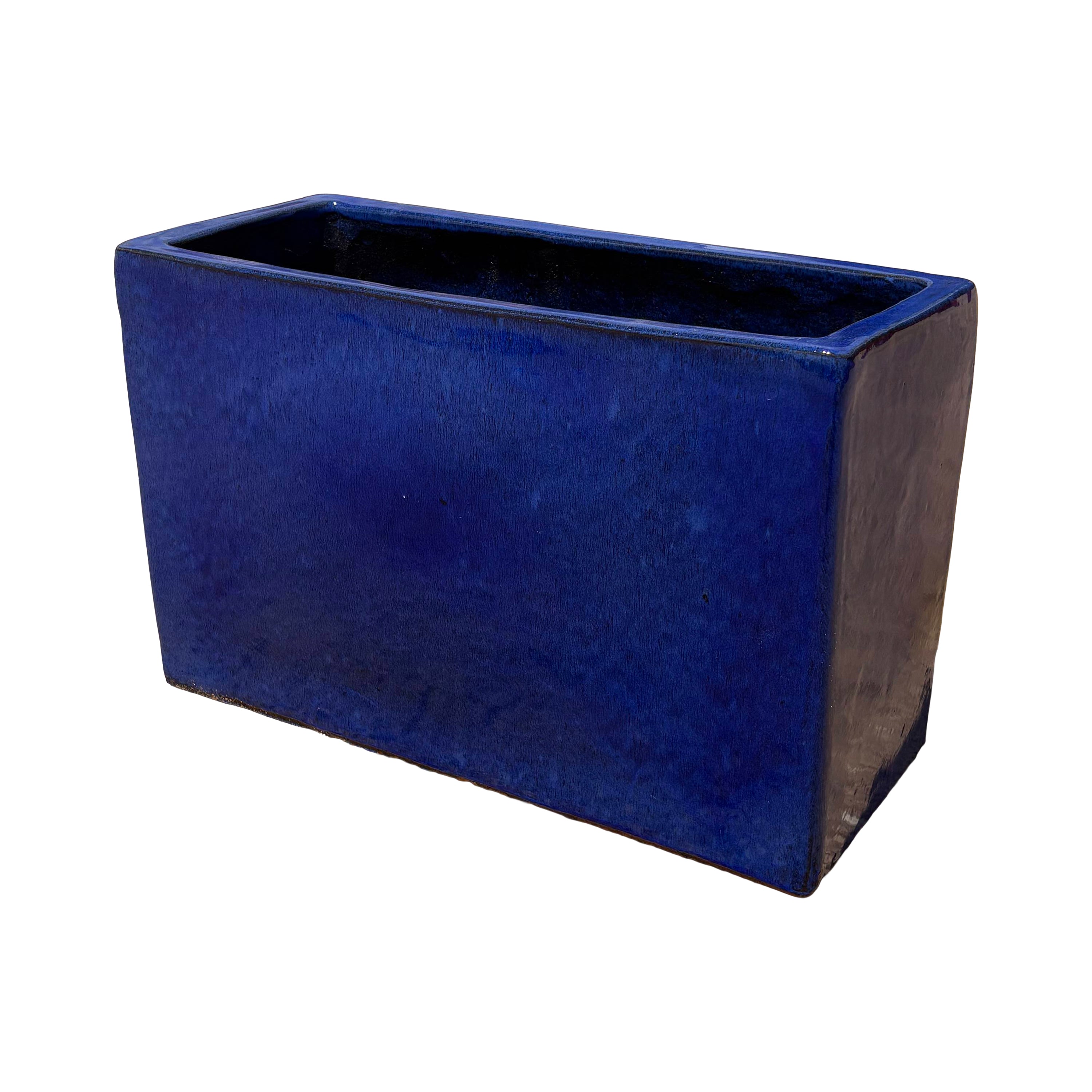 Falling blue glazed rectangular ceramic planter shown from an angled side view, emphasizing its depth and smooth glazed surface.