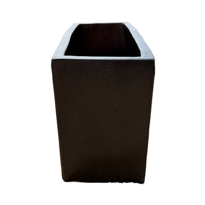 Short side view of the matte black glazed rectangular ceramic planter highlighting its compact end profile and matte surface.