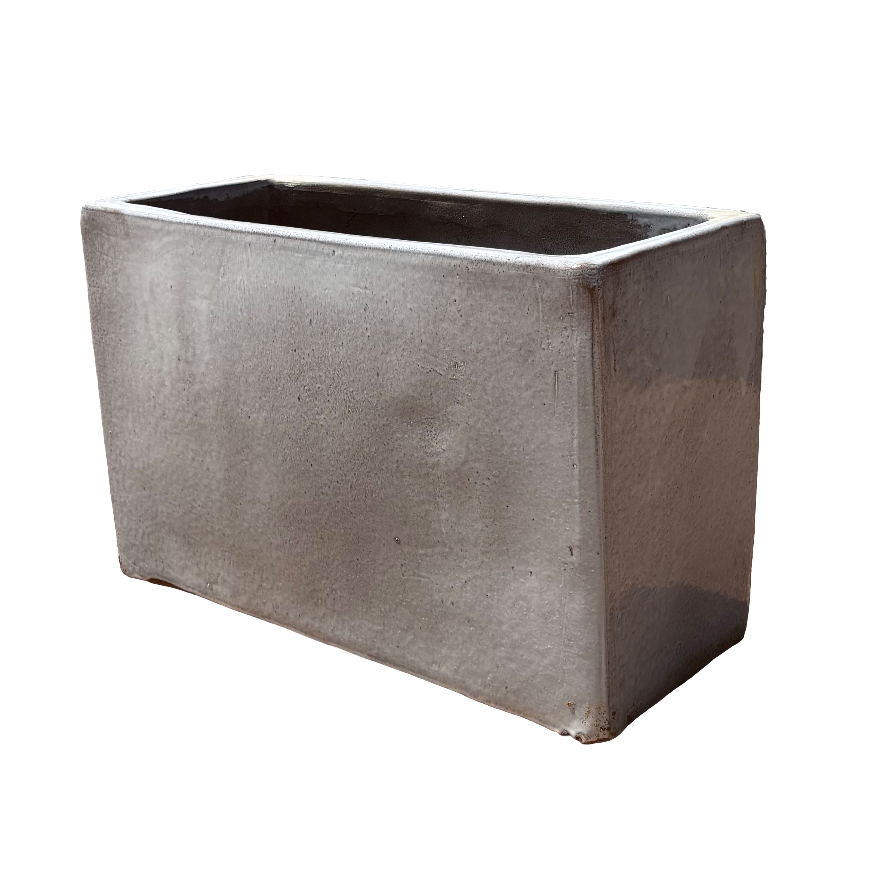 White glazed rectangular ceramic planter shown from an angled side view, emphasizing its depth and refined glazed surface.