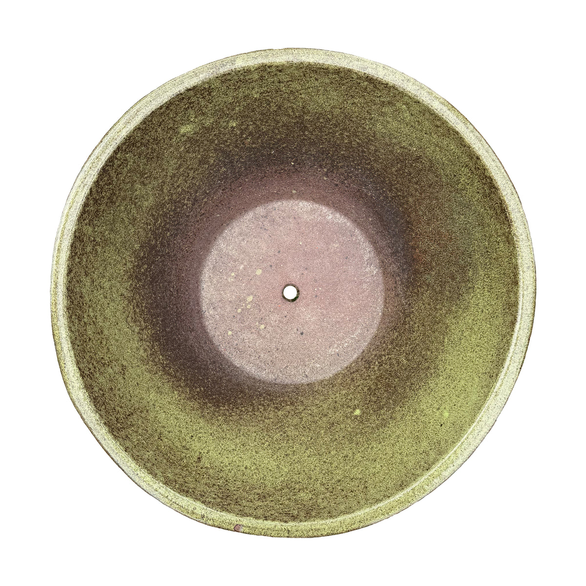 A top-down view of a round ceramic bowl planter with a textured glaze that transitions from olive green to earthy brown, featuring a small drainage hole in the center.