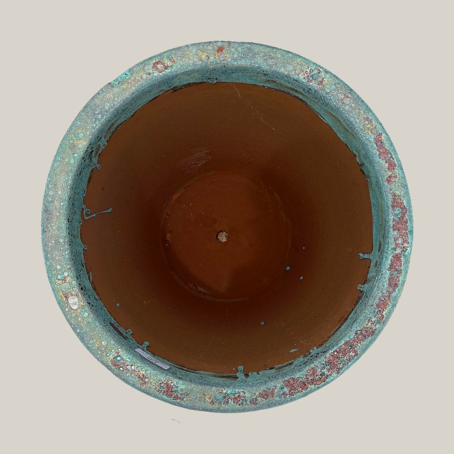 Top view of marble green coral tapered planter showing wide circular opening and interior finish