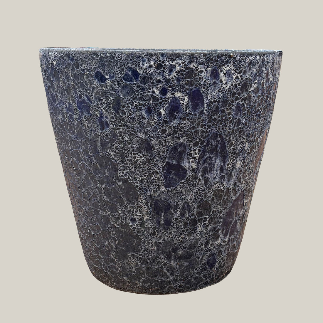 Front view of blue coral tapered planter with bold tapered silhouette and decorative coral-textured surface in deep blue tones
