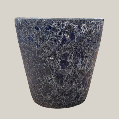 Front view of blue coral tapered planter with bold tapered silhouette and decorative coral-textured surface in deep blue tones