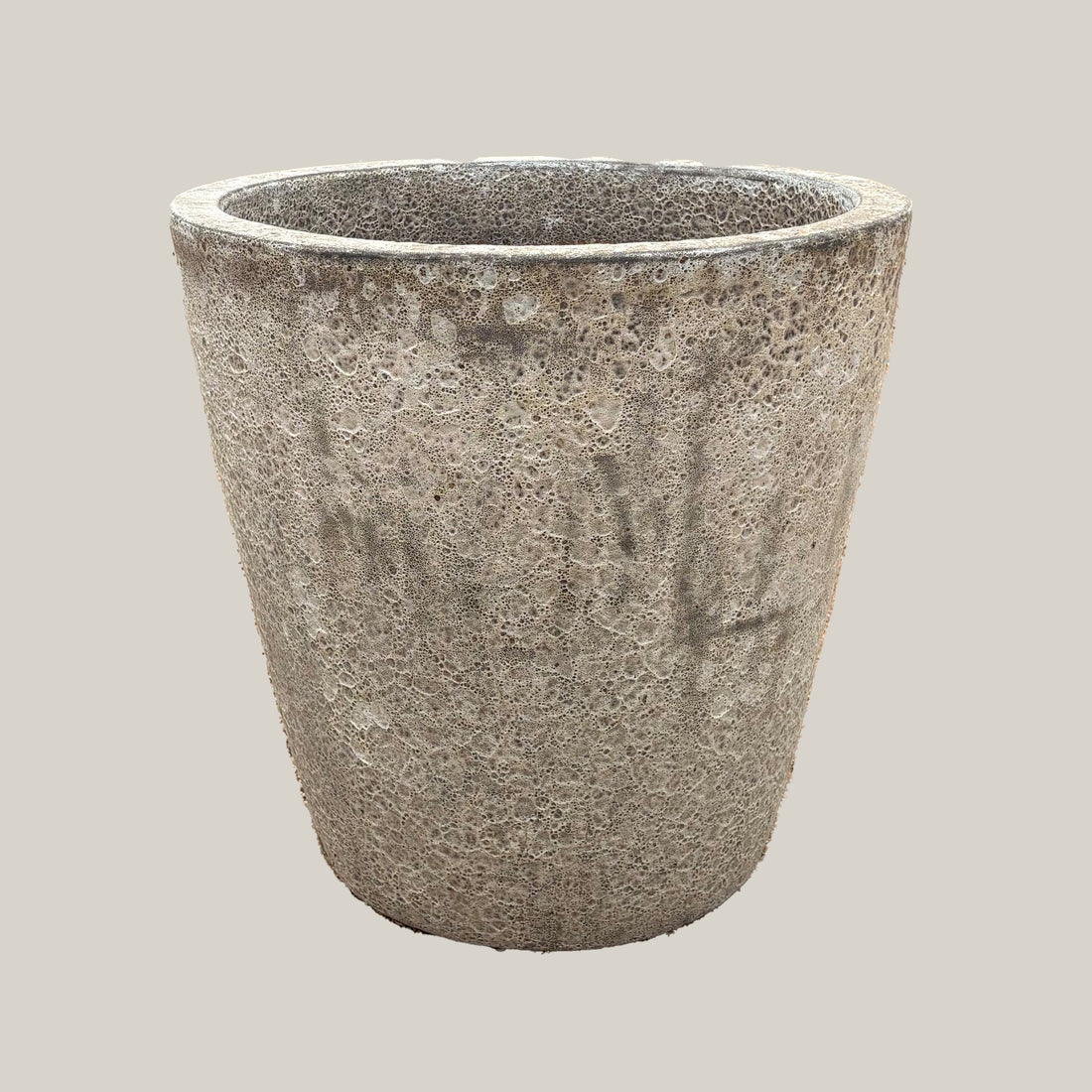 Gray coral tapered planter with rounded egg-shaped form and textured stone-like gray finish, slightly angled view highlighting natural surface