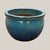 Turquoise round bowl planter with glossy glaze and wide low-profile shape, slightly angled view showing subtle color variation