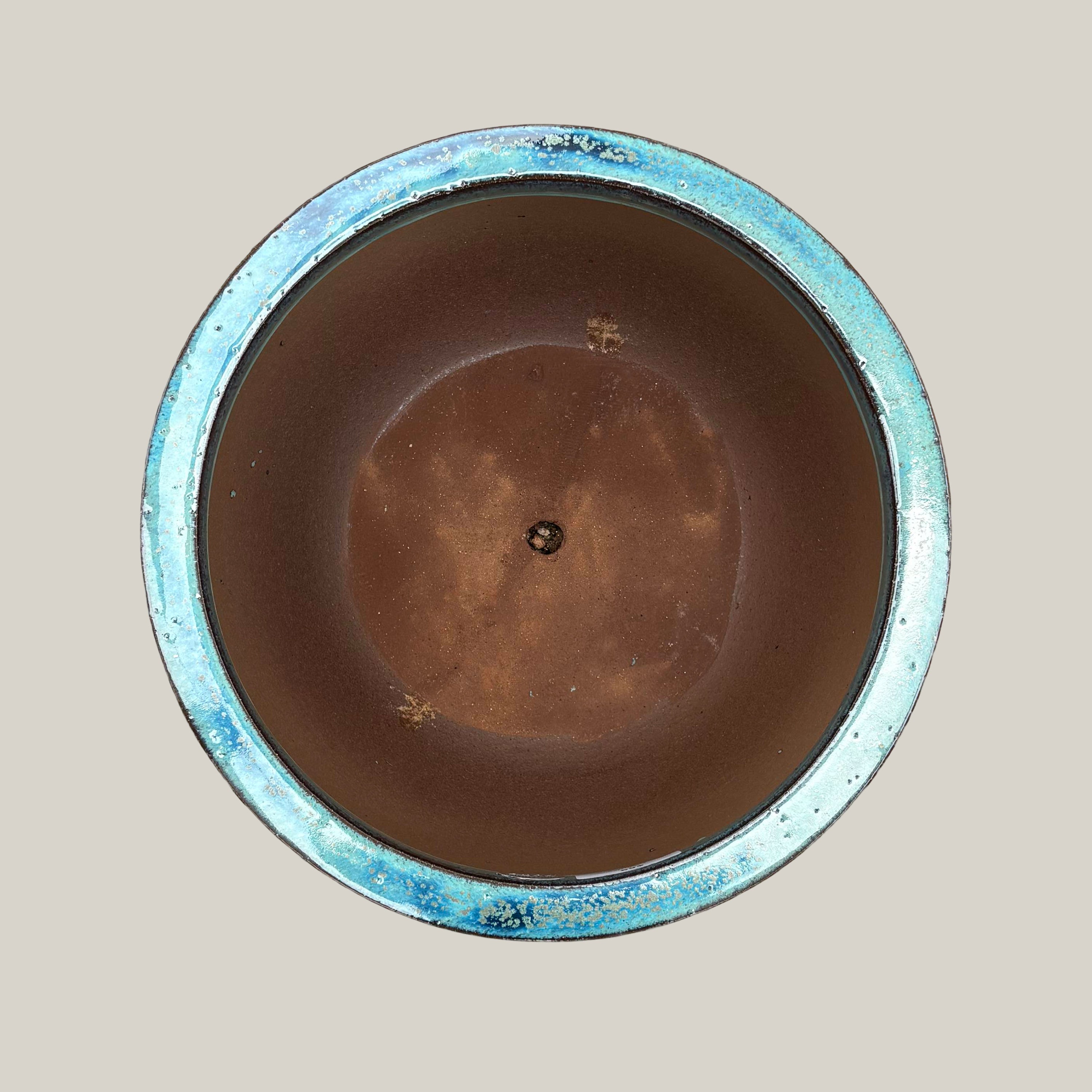 Top view of turquoise round bowl planter showing wide opening and rounded interior form
