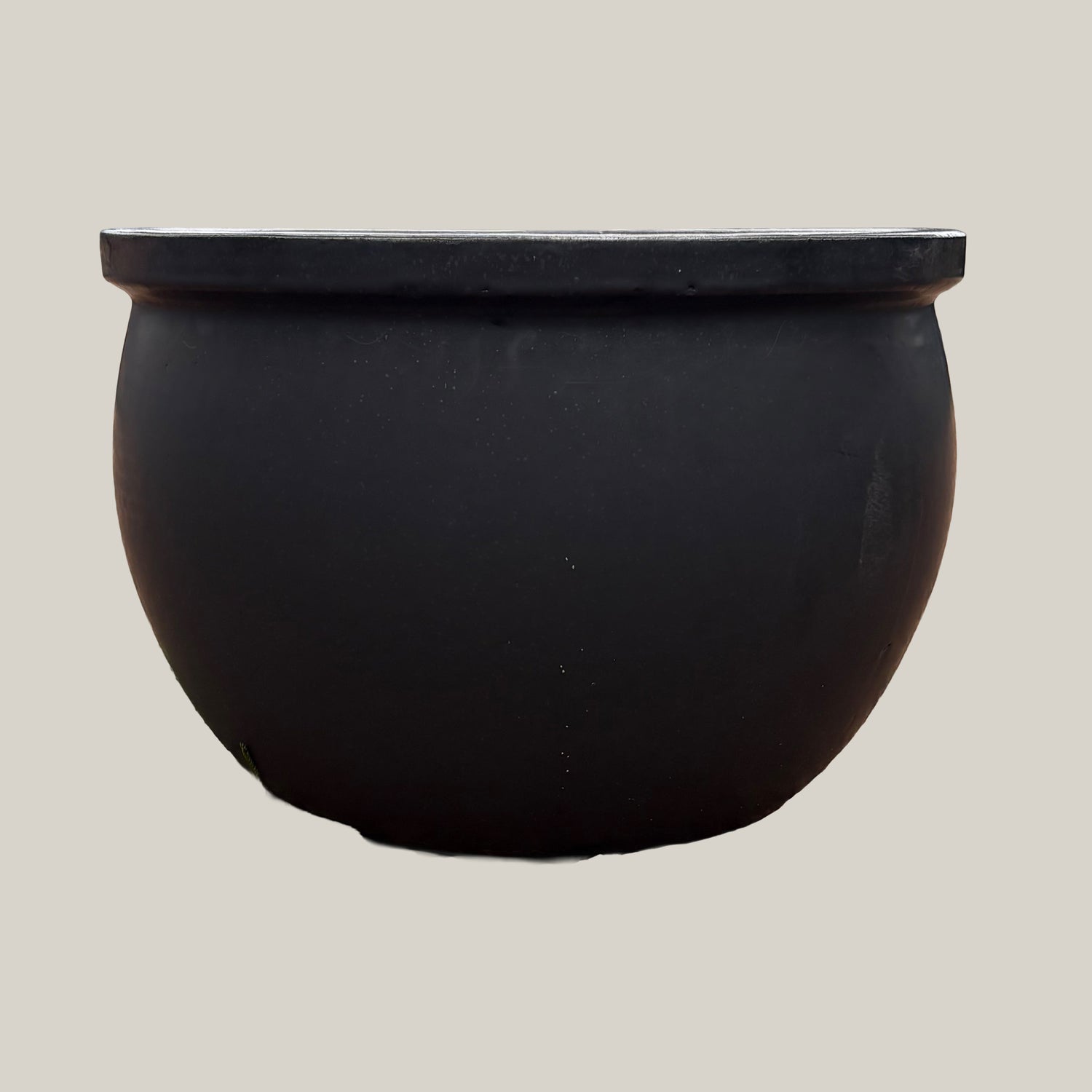 Front view of matte black round bowl planter with clean, modern bowl shape and understated matte surface