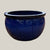 Blue round bowl planter with deep blue glazed finish, slightly angled view showing its wide silhouette