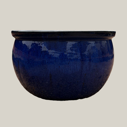 Front view of blue round bowl planter with a low-profile shape and rich glazed finish