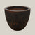 Black coral lion egg planter with rounded egg-shaped form and textured dark coral finish, slightly angled view highlighting earthy tones