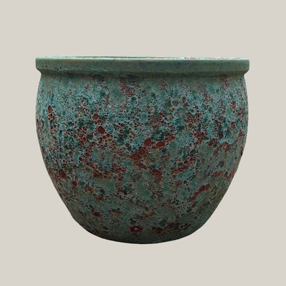 Front view of turquoise coral round low bowl planter with rounded low-profile shape and textured glaze