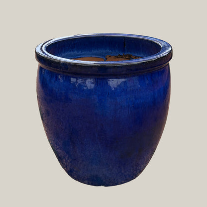 Blue belly planter with full, rounded body and glossy blue glaze, slightly angled view highlighting its curved silhouette