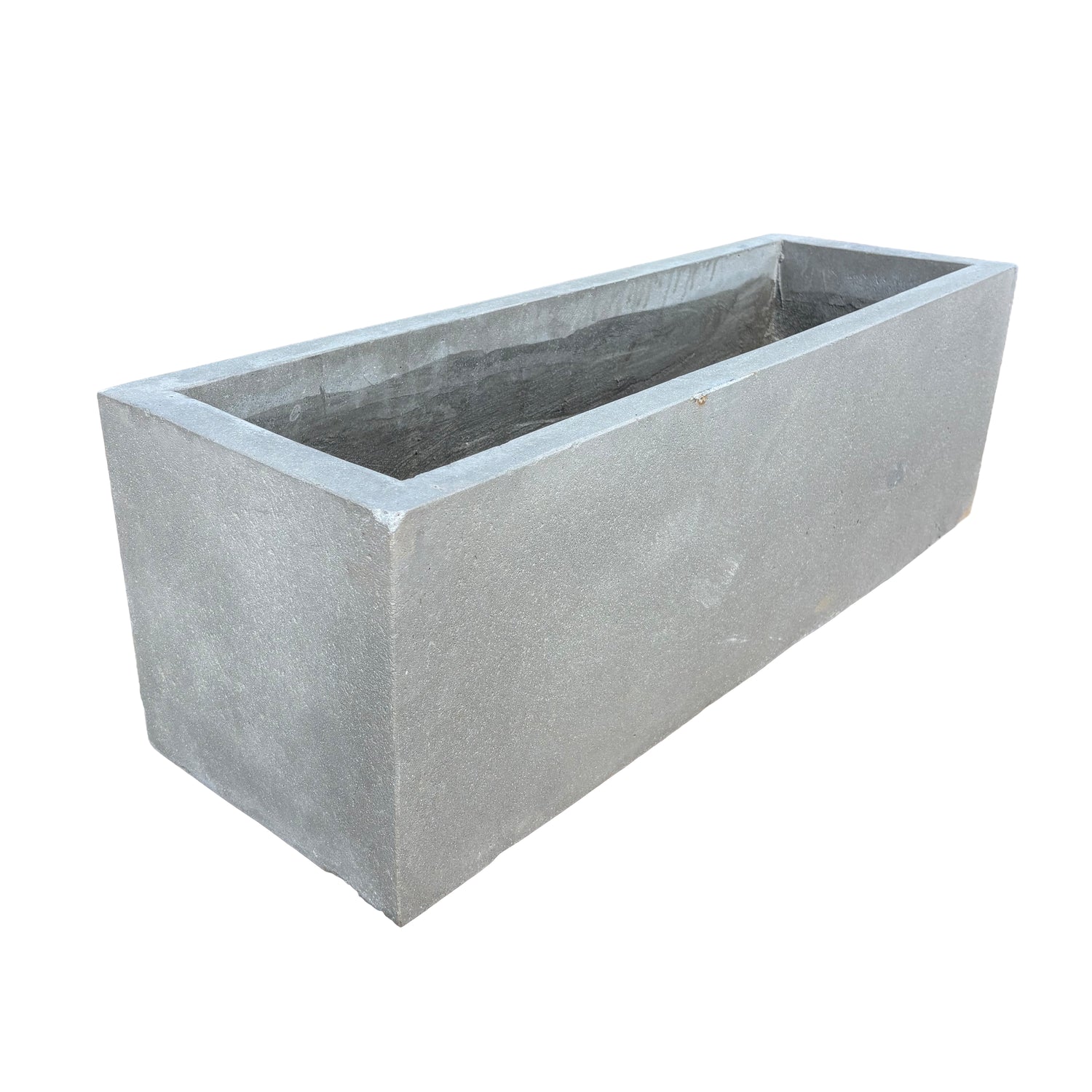 Low grey rectangular fiberstone planter viewed at an angle, showcasing its sleek lines, shallow depth, and modern stone-look texture.